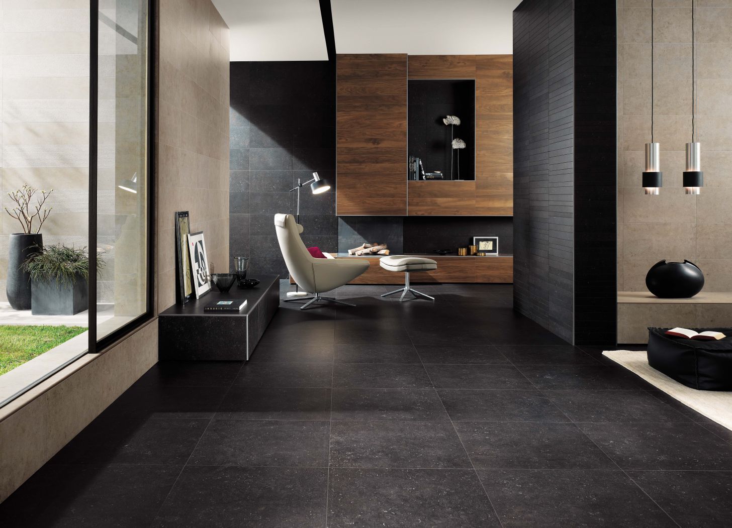 Large modern room with several types of tile, furnished with a white armchair